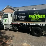A vacuum truck from Septic Panther parked outside of a residential home.