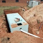 Newly installed septic tank in a residential backyard.