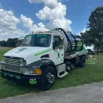A closeup of the front of a vacuum truck from "Septic Panther LLC".