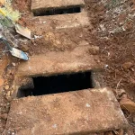 Close-up of two septic tank entry holes.