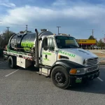 A closeup of the front of a vacuum truck from "Septic Panther LLC".