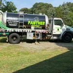 A closeup of the side of a vacuum truck from "Septic Panther LLC".